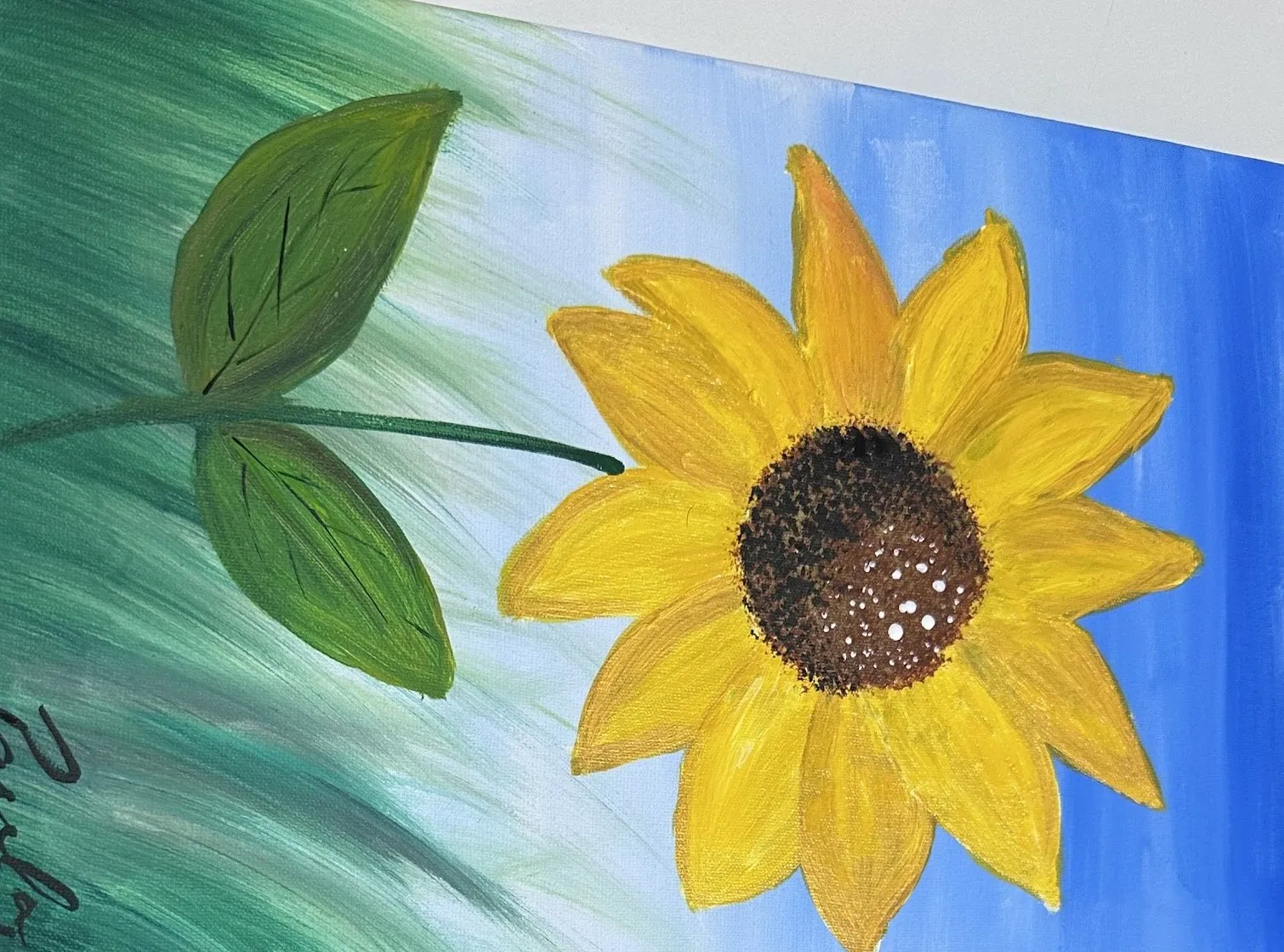 Tela com um girassol amarelo sobre fundo azul e verde, assinada por Paula.